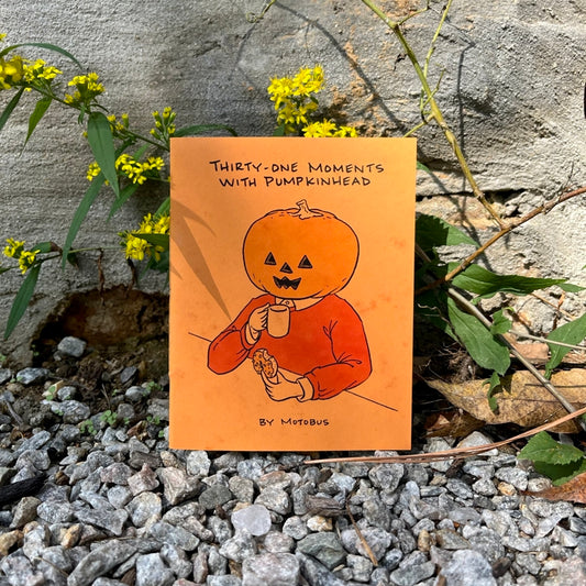 Mini comic titled 'Thirty-One Moments with Pumpkinhead' by Motobus on a rocky ground with yellow flowers.