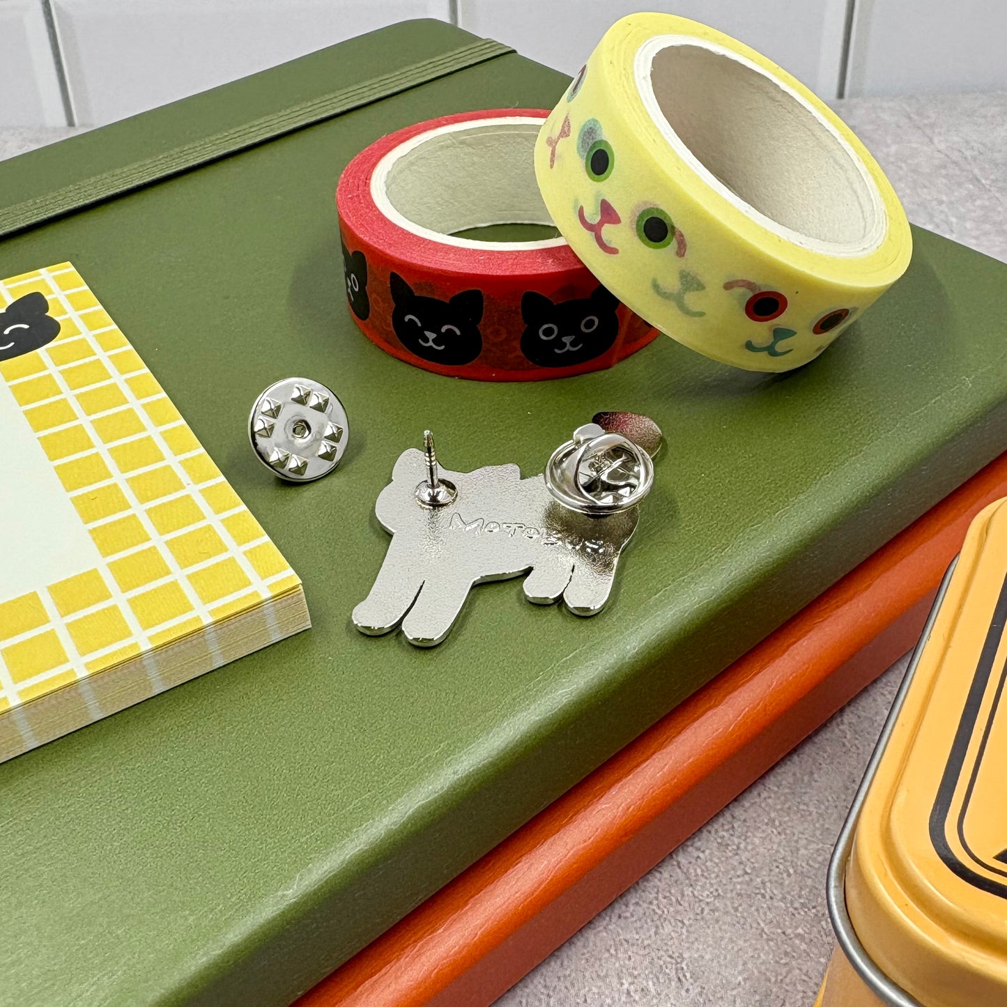 Decorative tape, pins, and small notebooks