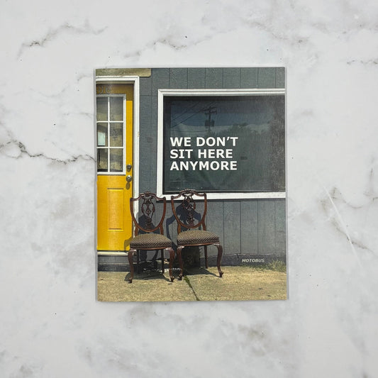 Book cover with two chairs in front of a yellow door on a marble surface
